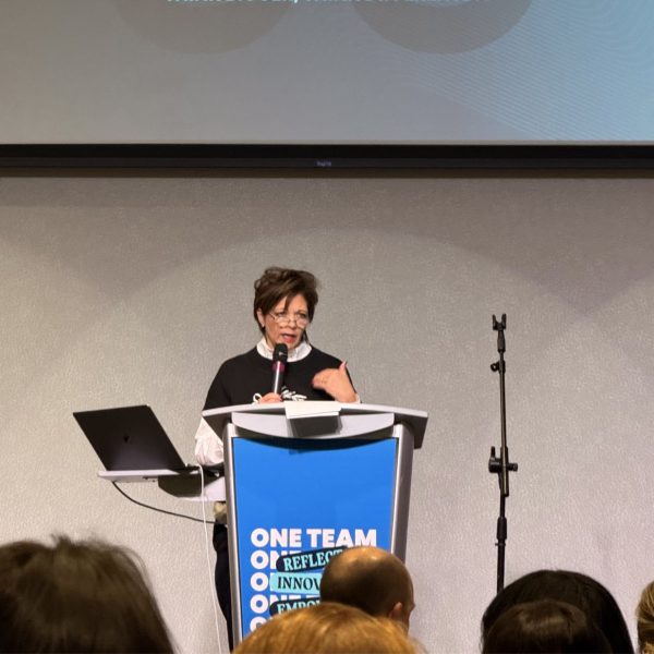 Laurie Fleck presenting at a podium